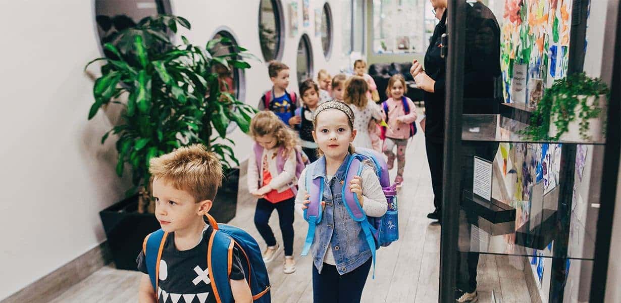 Children in centre wearing backpacks