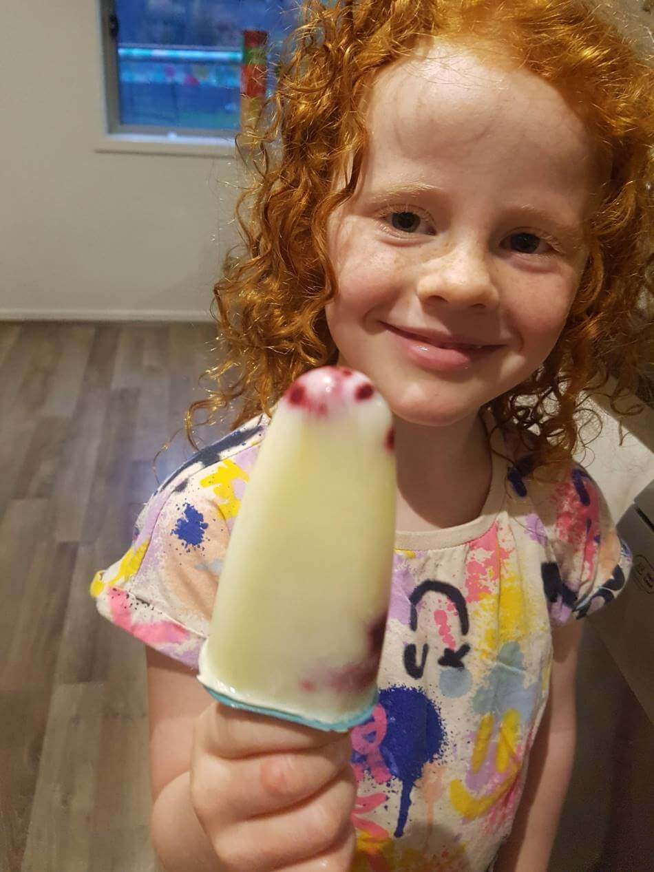 child holding homemade ice block