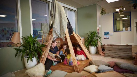 Educator and 2 children at Guardian George St playing in indoor teepee