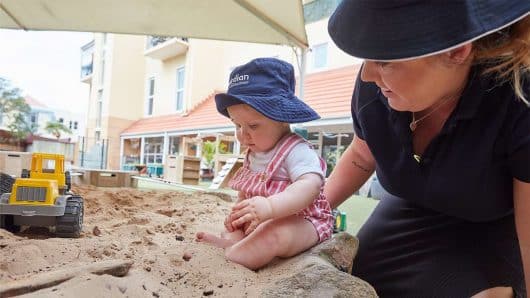 Toddler with Educator in sandpit at Balmain Cove
