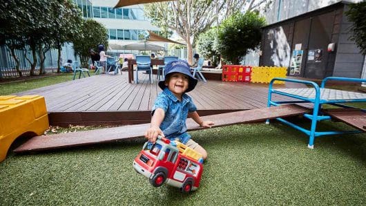 Child playing with truck outside at Pymble