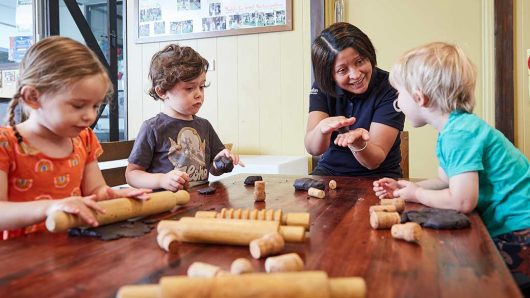 Children playing with toys inside and educator Lilyfield