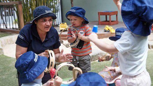 Children playing with music instruments and educator at Lilyfield